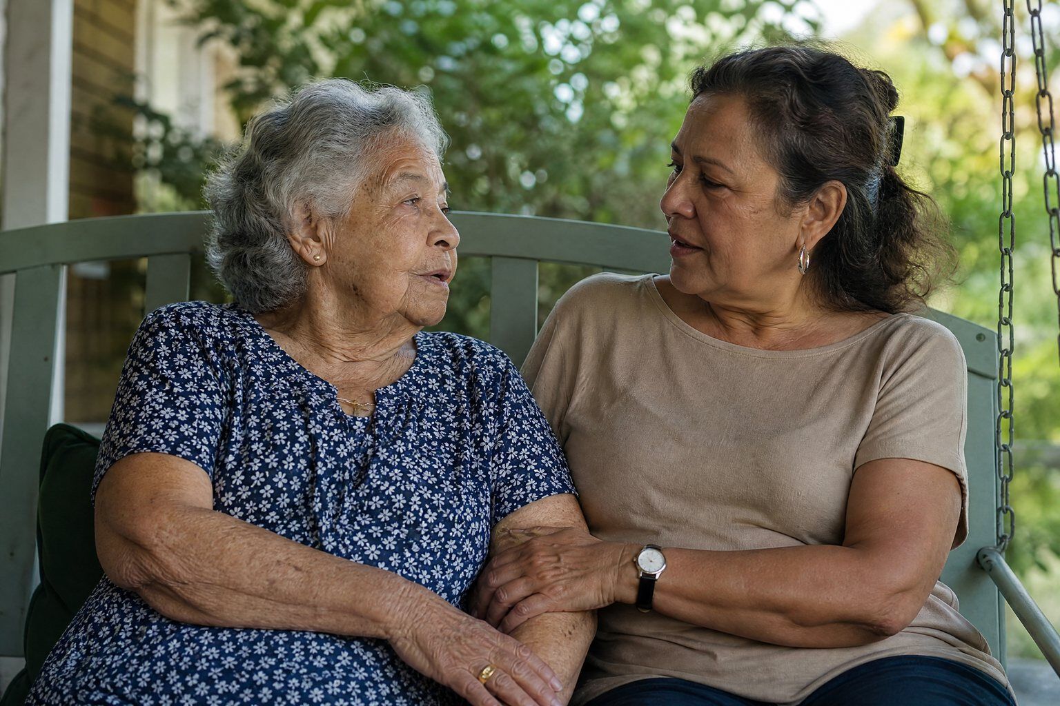 A mother and daughter talking on a porch swing